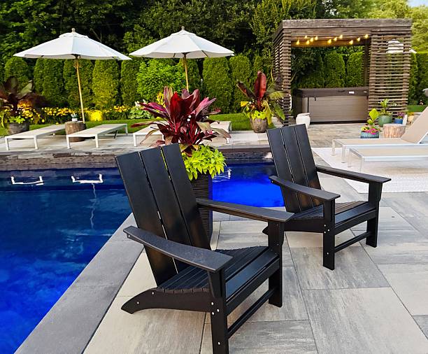 istock Beautiful, luxury, modern backyard lounge area with umbrella and lounge chairs poolside. 2222148182