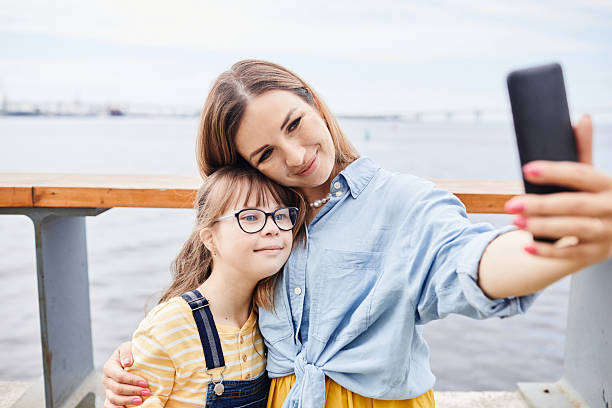 istock Mom and Daughter Taking Photo by River 2222149523