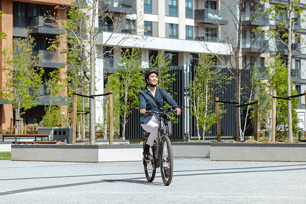 istock Professional commuting woman riding bicycle on sunny urban day 2222153390