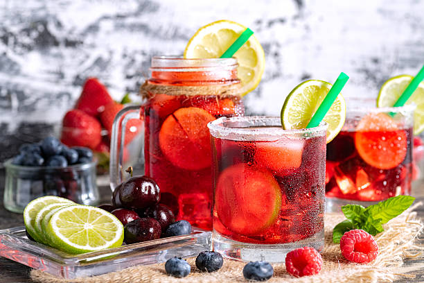 istock Refreshing berry cocktail with ice and lemon. Raspberry, lime, strawberry, blueberry, and leaves mint. Berry mojito close-up. 2222154013