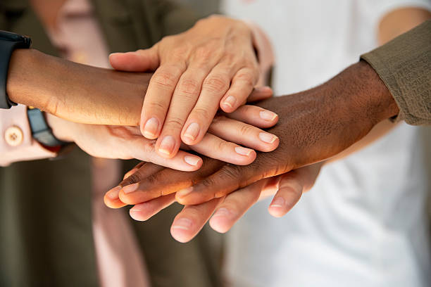 istock Colleagues joining their hands in solidarity 2222154842