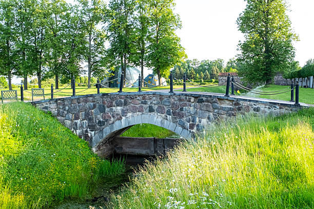 Stone pedestrian bridge of ancient construction. Public park