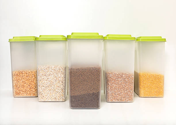 istock Various cereals - wheat, buckwheat, millet, barley in closed plastic transparent containers for bulk products, standing in a row, on a white background 2222157554
