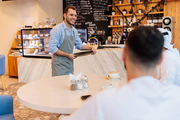 istock Friendly Service Interaction in Dubai Coffee Shop 2222158344