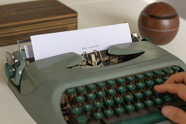 istock Writer typing stay positive on vintage typewriter encouraging optimism 2222166059
