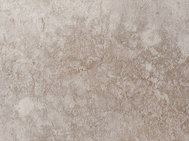 istock Rough textured light beige surface resembling natural stone or concrete, ideal for backgrounds, rustic designs, or material samples 2222166380