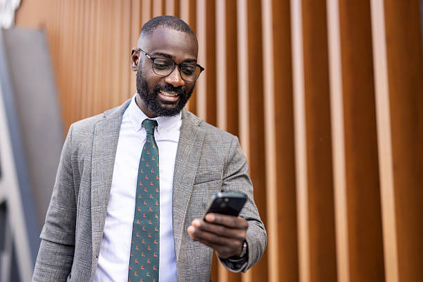 istock Man in Suit Checking Phone, Urban Environment, Happy Mood 2222168940