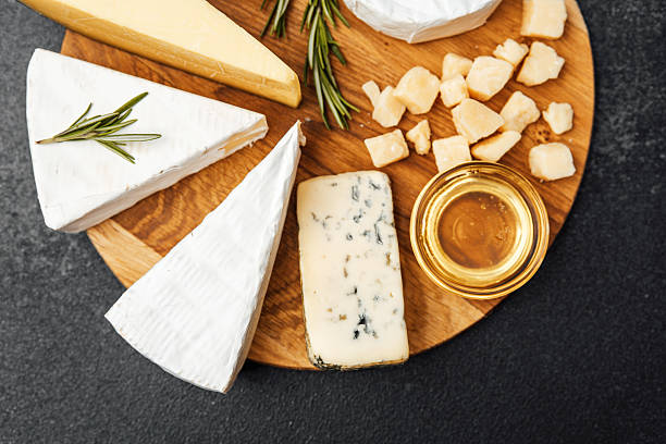 istock Elegant cheese platter with assorted varieties and honey on a rustic board 2222169806