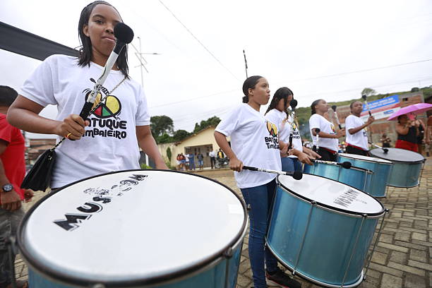 itamari, bahia, brazil - december 9, 2023: young women members of a percussion band are seen during a performance in the city of Itamaria.