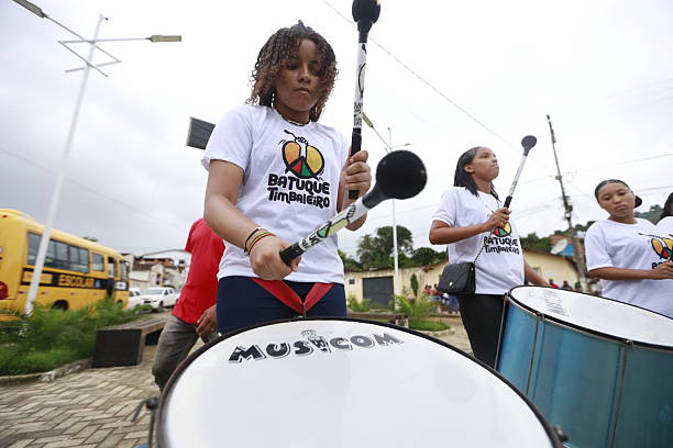 itamari, bahia, brazil - december 9, 2023: young women members of a percussion band are seen during a performance in the city of Itamaria.