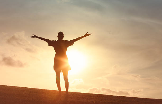 istock Woman enjoying beautiful peaceful sunset setting. 2222172067