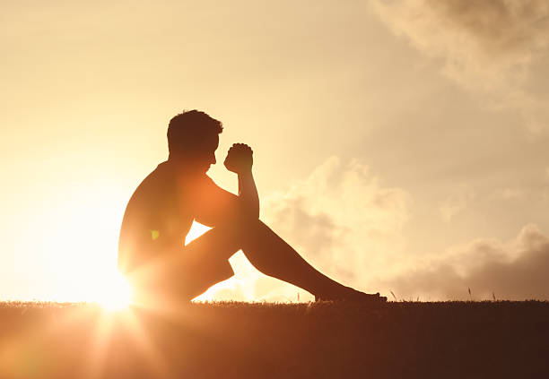 istock Man folding his hands in worship saying a prayer 2222172104