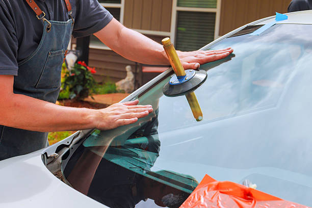 istock Technician replaces windshield in residential area during works day hours 2222173775
