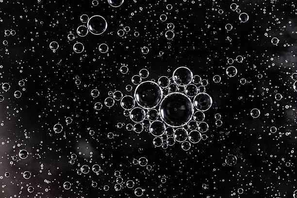 istock Black oil drops on the water surface. 2222174853