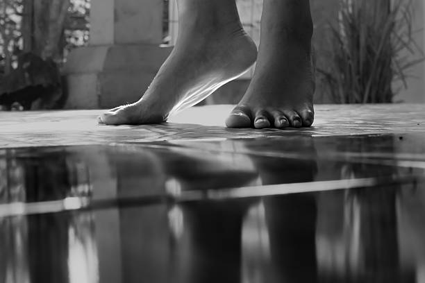 istock Bare Feet and Reflection on Floor – Black and White Minimalist Concept 2222181610