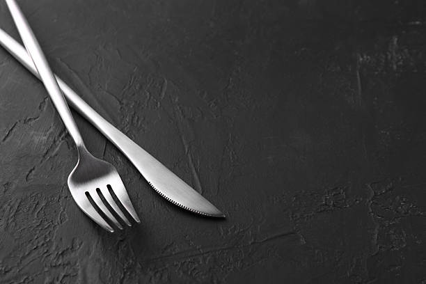 istock Beautiful cutlery set on black table. Space for text 2222182238