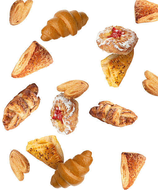 istock Different tasty puff pastries falling on white background 2222183095