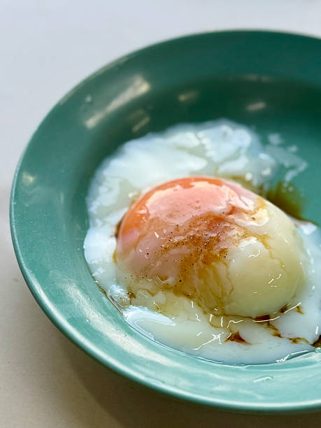 Traditional soft-boiled egg with soy sauce and pepper