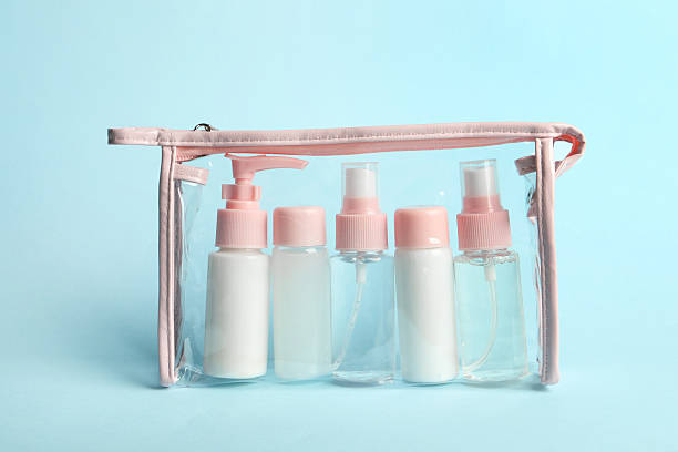 istock Cosmetic travel kit in plastic bag on light blue background 2222188784