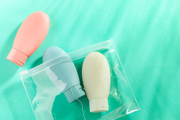 istock Cosmetic travel kit with plastic bag on turquoise background, top view. Space for text 2222188797