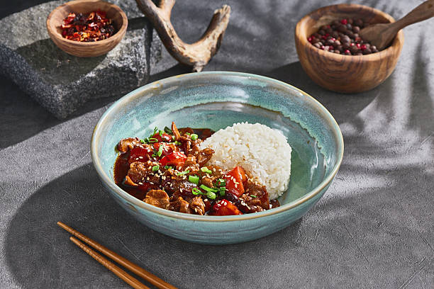 istock Pork stir fry wok with steamed rice, bright midday, overhead composition showcasing ceramic dish 2222190471