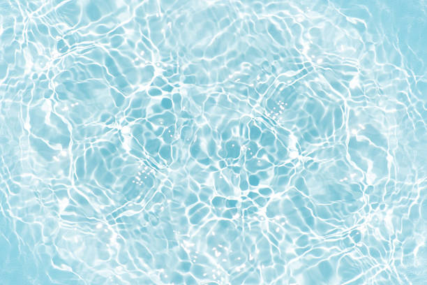istock Blue water with ripples on the surface. Defocus blurred transparent blue colored clear calm water surface texture with splashes and bubbles. Water waves with shining pattern texture background. 2222195684