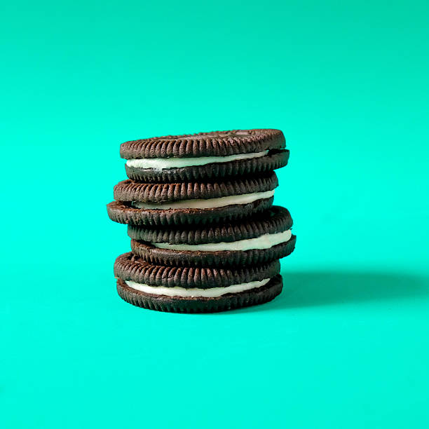 Chocolate cookie with cream on background.