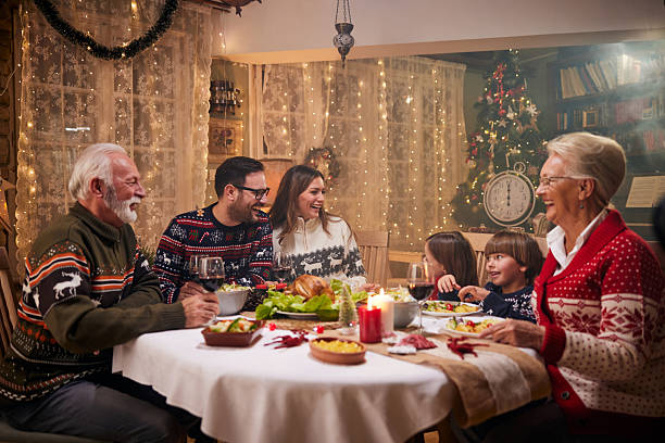 istock Cheerful extended family talking during Christmas dinner at home. 2222198451