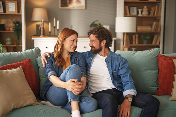 istock Happy couple relaxing and talking on sofa at home 2222199692