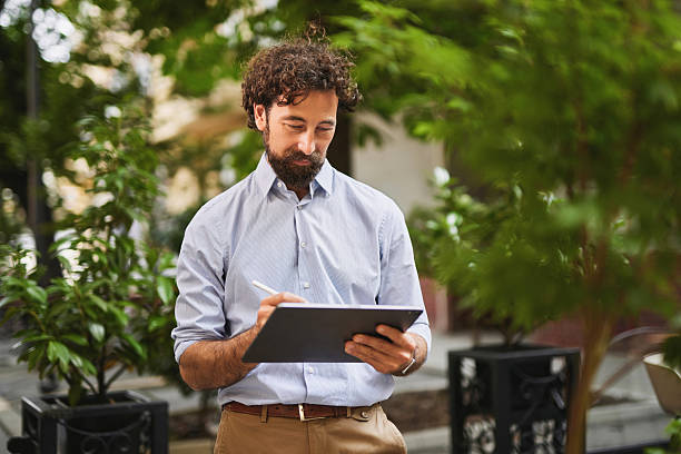 istock Businessman working with digital tablet outdoors in urban setting 2222200881