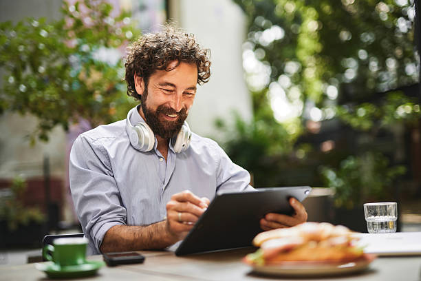 istock Freelancer enjoying working at outdoor cafe using digital tablet 2222201172