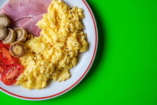 istock Scrambled Eggs With Fresh Tomatoes Fried Mushrooms and Slices Of Cooked Ham 2222202461
