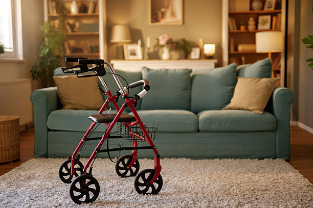 Empty walker parked on rug in living room, symbolizing aging in place and the need for assistive devices for seniors