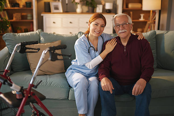 istock Home nurse caring for elderly man on sofa with walker nearby 2222204650