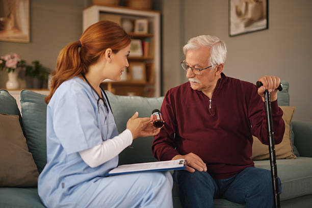 istock Home caregiver assisting senior man with his medication 2222205506
