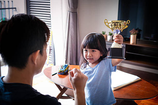istock Elementary school girl's  golden trophy for academic excellence 2222206798