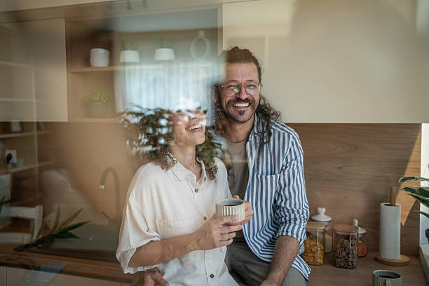 istock Happy couple enjoying morning coffee in modern kitchen 2222208365