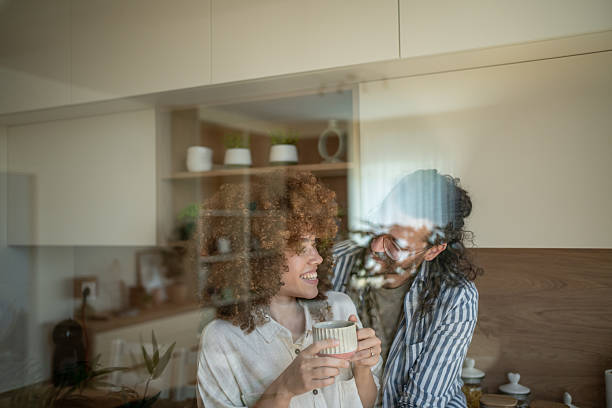 istock Young couple sharing a moment in the kitchen, drinking coffee 2222208373