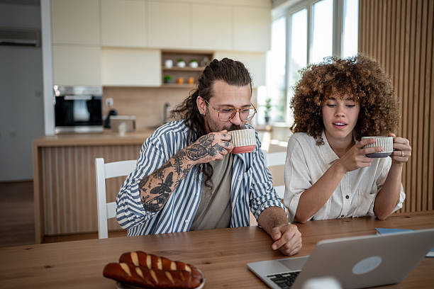 istock Young couple enjoying coffee and online content at home 2222208601