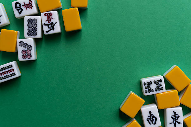 istock Mahjong tiles lined up on a green background 2222212605