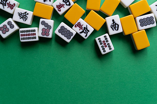 istock Mahjong tiles lined up on a green background 2222212653