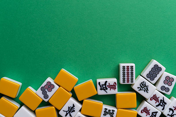 istock Mahjong tiles lined up on a green background 2222212693