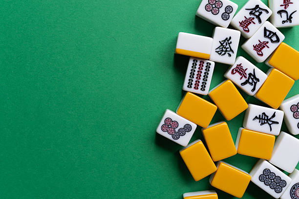 istock Mahjong tiles lined up on a green background 2222212717
