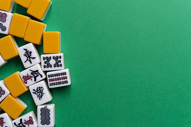 istock Mahjong tiles lined up on a green background 2222212743