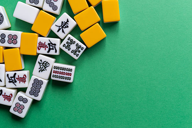 istock Mahjong tiles lined up on a green background 2222212767