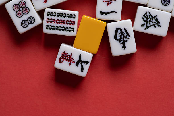 istock Mahjong tiles lined up on a red background 2222213226