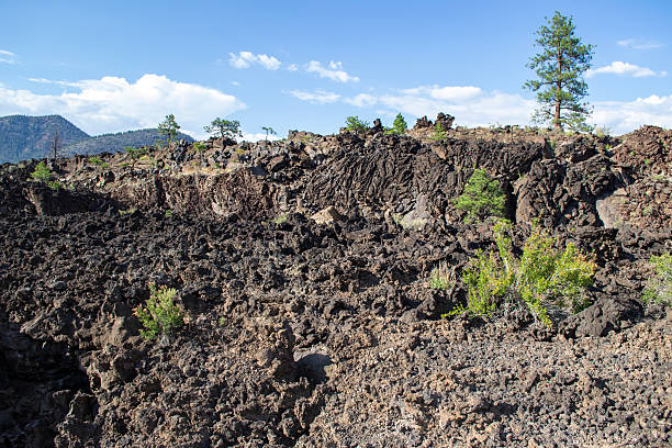 istock Lava field with rugged terrain and sparse vegetation in a volcanic landscape under a bright blue sky 2222215238