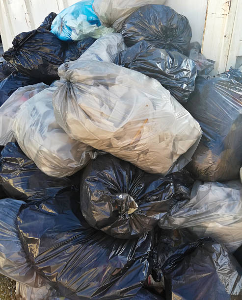 istock trash bags near the dumpster 2222216879