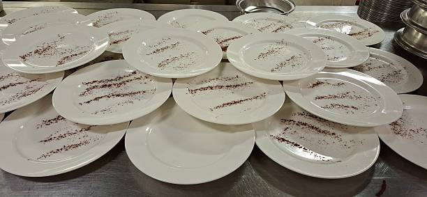 istock Empty Dessert Plates with Cocoa Powder Decoration in a Professional Kitchen 2222217817