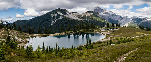 istock Scenic mountain landscape featuring serene lakes and lush greenery under a cloudy sky in summer 2222217876